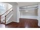 Open-concept living room showcasing stairs, hardwood flooring, columns, and windows at 201 Masterwood Way, Morrisville, NC 27560