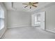 Spacious carpeted bedroom features a trey ceiling, ceiling fan, and ensuite bathroom access at 201 Masterwood Way, Morrisville, NC 27560