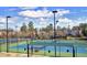 An aerial view shows multiple tennis courts with lighting and fencing, offering a comprehensive recreational facility at 201 Masterwood Way, Morrisville, NC 27560
