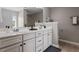 Bathroom features double sinks, white cabinetry, and neutral wall colors at 2060 Jersey City Pl, Apex, NC 27523