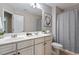 Bathroom featuring double sinks, white cabinetry, and a shower with a curtain at 2060 Jersey City Pl, Apex, NC 27523