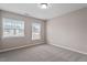 Neutral bedroom featuring two large windows and neutral carpeting at 2060 Jersey City Pl, Apex, NC 27523