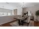Elegant dining room with a modern chandelier, stone accent wall, and coordinated decor at 2060 Jersey City Pl, Apex, NC 27523