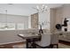 Elegant dining room featuring a modern chandelier, stone accent wall, and stylish furniture at 2060 Jersey City Pl, Apex, NC 27523