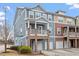 Charming townhome exterior with stone accents, private garages, and well-maintained landscaping at 2060 Jersey City Pl, Apex, NC 27523