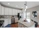 Well-lit kitchen with granite countertops, stainless steel appliances, and modern white cabinets at 2060 Jersey City Pl, Apex, NC 27523