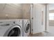 Functional laundry room with modern washer and dryer and overhead shelving at 2060 Jersey City Pl, Apex, NC 27523