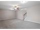 Spacious living room with plush carpeting, ceiling fan, and a staircase leading to the next level at 2060 Jersey City Pl, Apex, NC 27523