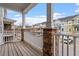 Charming porch with stone-based pillars and a view of the colorful townhome community at 2060 Jersey City Pl, Apex, NC 27523