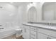 Bright bathroom featuring double vanity with stone countertops, white cabinetry, bathtub and arched mirrors at 2101 Wimberly Woods Dr, Sanford, NC 27330
