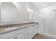 Bright bathroom featuring double vanity with stone countertops, white cabinetry, and tiled shower at 2101 Wimberly Woods Dr, Sanford, NC 27330