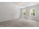 Bright bedroom with plush carpeting, recessed lighting, and a pair of windows overlooking nature at 2101 Wimberly Woods Dr, Sanford, NC 27330