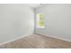 Cozy bedroom with wood-style flooring, neutral walls, and bright window overlooking nature at 2101 Wimberly Woods Dr, Sanford, NC 27330