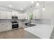 Modern kitchen with white cabinetry, stainless steel appliances, and a stylish island with quartz countertops at 2101 Wimberly Woods Dr, Sanford, NC 27330