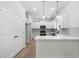 Bright kitchen features white cabinets, stainless appliances, quartz counters, and wood grain flooring at 2101 Wimberly Woods Dr, Sanford, NC 27330