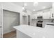Bright kitchen features white cabinets, stainless appliances, quartz counters, and wood grain flooring at 2101 Wimberly Woods Dr, Sanford, NC 27330