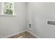Clean, bright laundry room with wood-look floors and a window for natural light at 2101 Wimberly Woods Dr, Sanford, NC 27330
