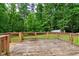 Spacious wooden deck with wooden railings overlooks a lush green and wooded backyard landscape at 224 Oakcrest Dr, Wake Forest, NC 27587