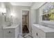 Bright bathroom featuring double sinks, vanity with marble countertops, and modern fixtures at 224 Oakcrest Dr, Wake Forest, NC 27587