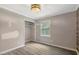 Bedroom showcasing gray laminate flooring and a closet, with natural light at 224 Oakcrest Dr, Wake Forest, NC 27587