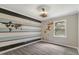 Bedroom showcasing gray laminate flooring, natural light, and a stylish accent wall at 224 Oakcrest Dr, Wake Forest, NC 27587