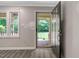 Inviting entryway with a sleek black door and a view of the greenery outside at 224 Oakcrest Dr, Wake Forest, NC 27587