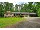 Charming ranch-style home featuring a welcoming front porch, carport, and lovely landscaped front yard at 224 Oakcrest Dr, Wake Forest, NC 27587