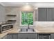 Well-appointed kitchen featuring updated cabinets, stainless sink and appliances, and a serene window view at 224 Oakcrest Dr, Wake Forest, NC 27587