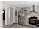 Contemporary kitchen with stainless steel refrigerator, sleek appliances, and ample counter space at 224 Oakcrest Dr, Wake Forest, NC 27587