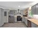 Modern kitchen featuring stainless steel appliances, light countertops, and ample cabinet space for storage at 224 Oakcrest Dr, Wake Forest, NC 27587