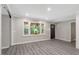 Bright living room with recessed lights, modern flooring, and a dark front door with large scenic window at 224 Oakcrest Dr, Wake Forest, NC 27587