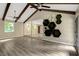 Open floorplan with sleek, modern living area and updated flooring and an open view into another living area at 224 Oakcrest Dr, Wake Forest, NC 27587