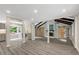Open-concept living area with exposed beams, barn doors, and views into a stylish kitchen space at 224 Oakcrest Dr, Wake Forest, NC 27587