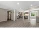 Bright, open-concept living area flowing into a modern kitchen with gray cabinetry and stainless appliances at 224 Oakcrest Dr, Wake Forest, NC 27587