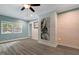 Bright living area features recessed lights, modern flooring, and a painted brick accent wall at 224 Oakcrest Dr, Wake Forest, NC 27587