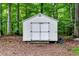 White storage shed in the backyard surrounded by trees at 224 Oakcrest Dr, Wake Forest, NC 27587