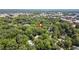 Scenic aerial shot with the house marked by a red pin, surrounded by green foliage, and city buildings in the background at 225 Vance St, Chapel Hill, NC 27516