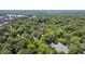 Aerial view showing the property location with a pin, surrounded by lush greenery, and distant buildings at 225 Vance St, Chapel Hill, NC 27516