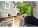 Backyard showing a wood fence, a deck and a grill, with a white railing and steps at 225 Vance St, Chapel Hill, NC 27516