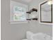 Bathroom featuring a sleek white toilet and vanity with open shelving, under a bright window at 225 Vance St, Chapel Hill, NC 27516
