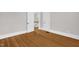 Bedroom featuring bright hardwood floors, showcasing an open doorway to a connecting staircase at 225 Vance St, Chapel Hill, NC 27516