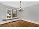Bright dining room featuring hardwood floors, a chandelier, and natural light from large windows at 225 Vance St, Chapel Hill, NC 27516