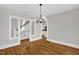 Bright dining room with hardwood floors, chandelier, and open access to the kitchen and staircase at 225 Vance St, Chapel Hill, NC 27516