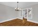 Bright dining room featuring hardwood floors, a chandelier, and an open view to the staircase at 225 Vance St, Chapel Hill, NC 27516