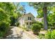 Charming two-story home with a inviting front porch, a gravel driveway, and mature trees at 225 Vance St, Chapel Hill, NC 27516