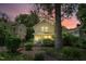 Charming two-story home with a brick walkway, lush landscaping, and a welcoming green front door at 225 Vance St, Chapel Hill, NC 27516