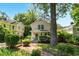 Charming two-story home with a brick walkway, lush landscaping, and a welcoming green front door at 225 Vance St, Chapel Hill, NC 27516