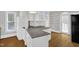 Modern kitchen with granite countertops, white cabinetry, and stainless steel appliances at 225 Vance St, Chapel Hill, NC 27516