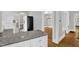 Open kitchen with granite countertops, white cabinets, and seamless flow into the dining area at 225 Vance St, Chapel Hill, NC 27516