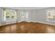 Bright living room featuring hardwood floors, large windows, and neutral wall colors at 225 Vance St, Chapel Hill, NC 27516